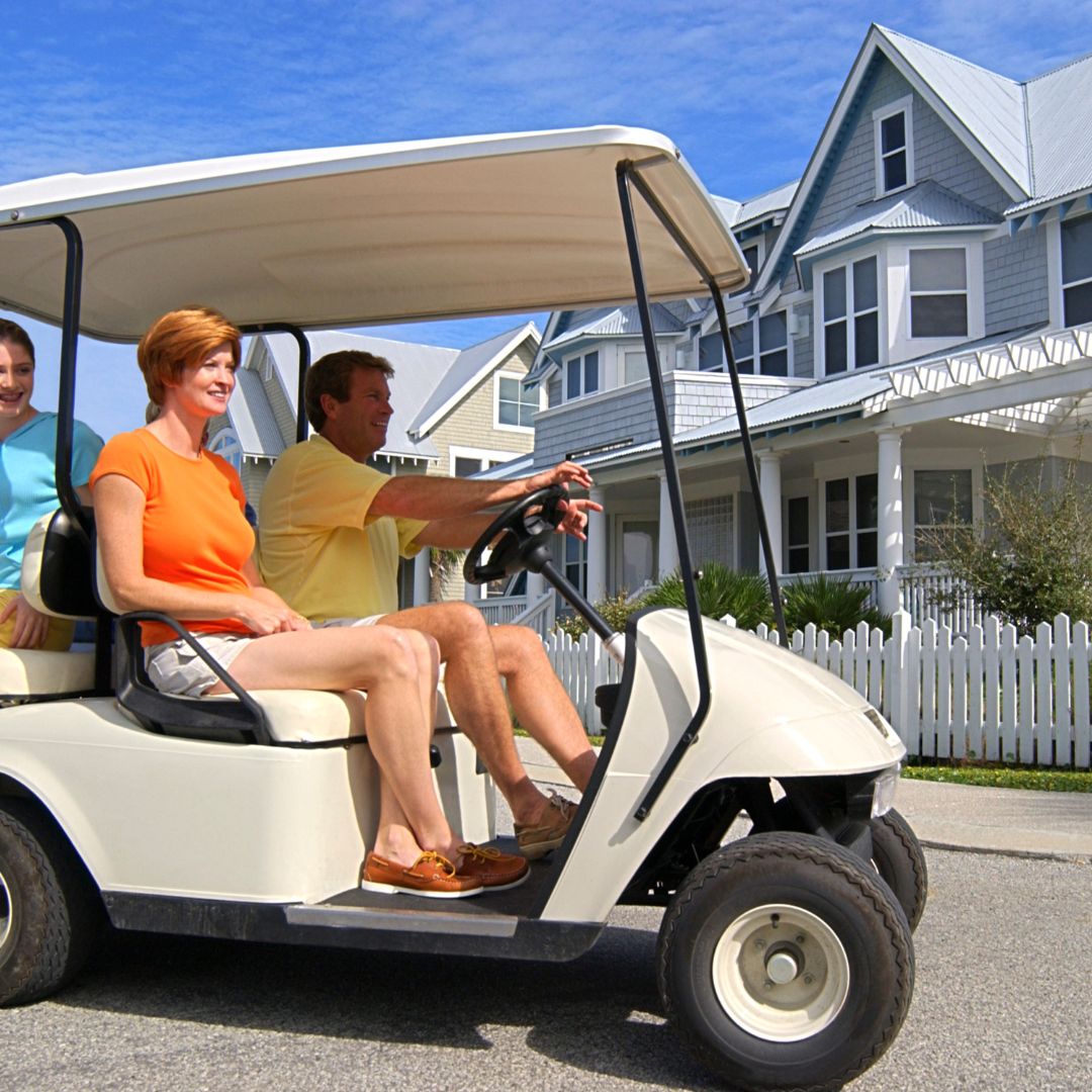 couple turning in a golf cart